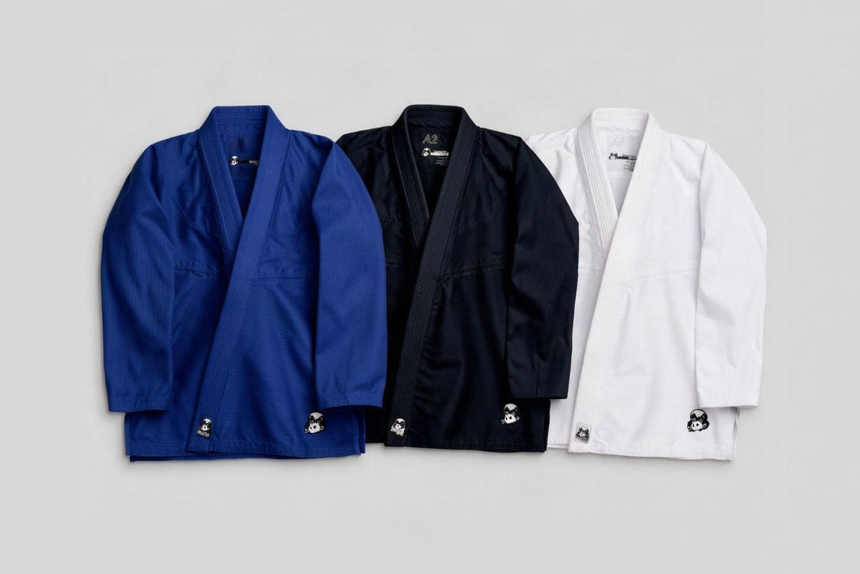 Three Minimalist Panda gis laid flat — blue, black and white, panda embroidered at the hem