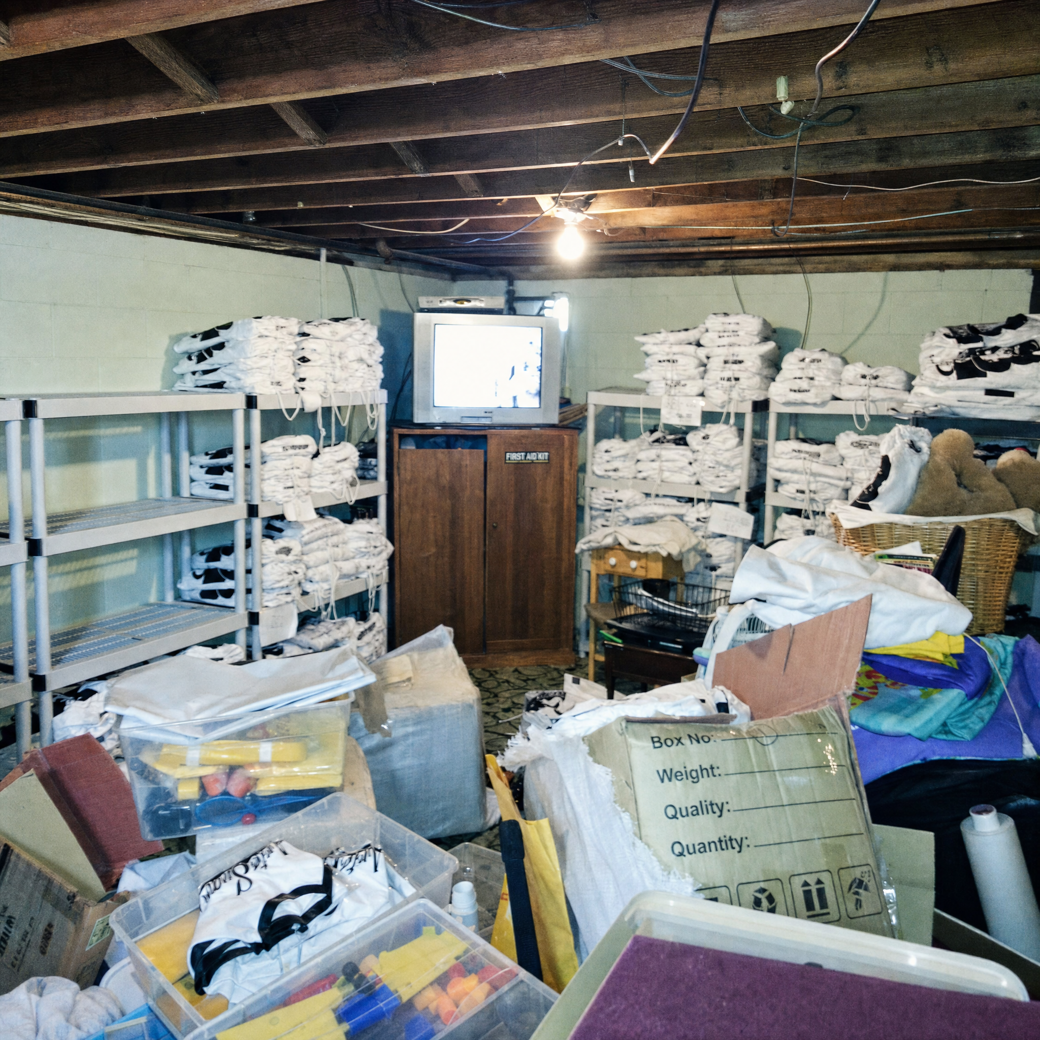 The basement warehouse: gis bagged on shelving under a bare bulb