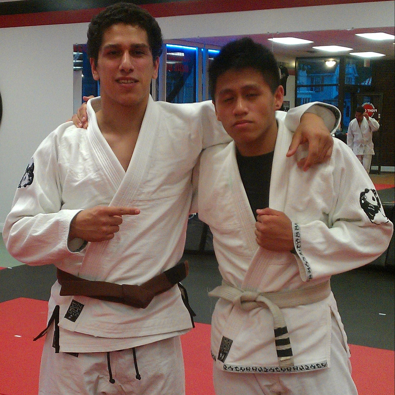 Two students in early Inverted Gear gis with panda shoulder patches