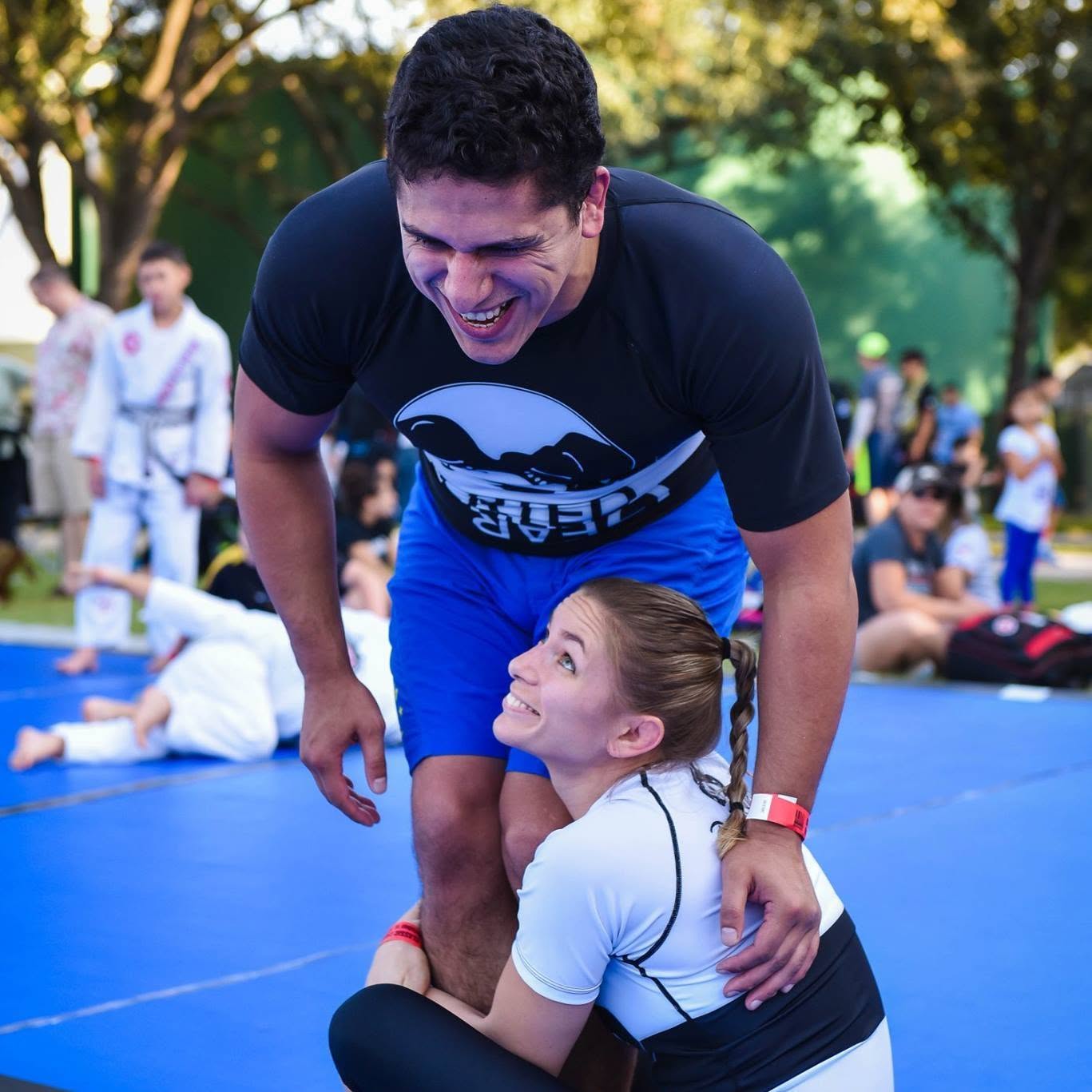 Hillary and Nelson laughing together on the mats