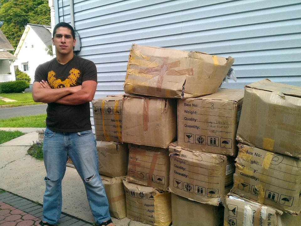 Nelson beside the first shipment of gis in factory cartons, 2012